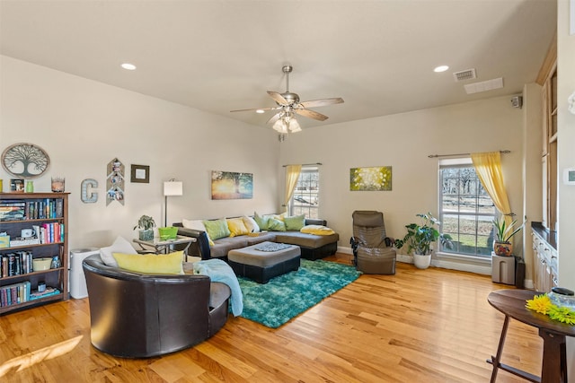 living room featuring recessed lighting, visible vents, a healthy amount of sunlight, and wood finished floors