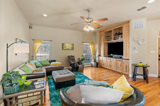 living room with recessed lighting, visible vents, light wood-style flooring, and a ceiling fan