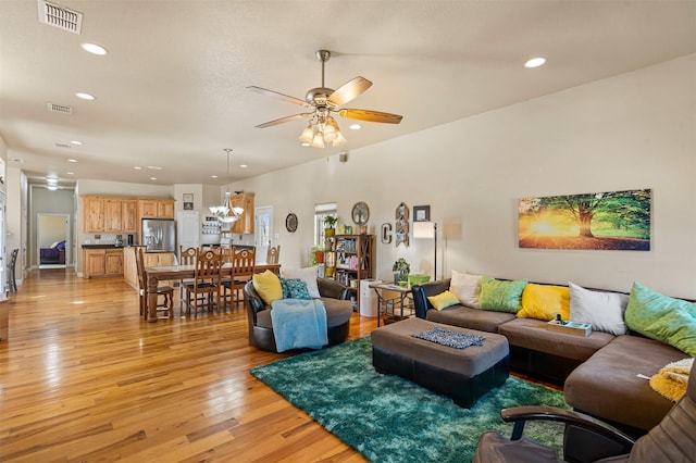 living area with recessed lighting, a ceiling fan, visible vents, and light wood finished floors
