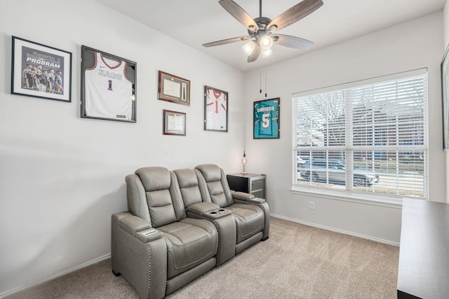 interior space with baseboards, carpet floors, and ceiling fan