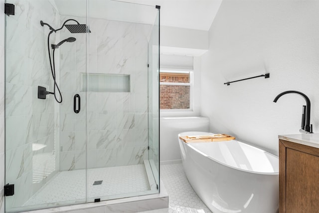 bathroom with vanity, a freestanding tub, and a stall shower