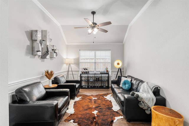 living room featuring vaulted ceiling, wood finished floors, a ceiling fan, and ornamental molding