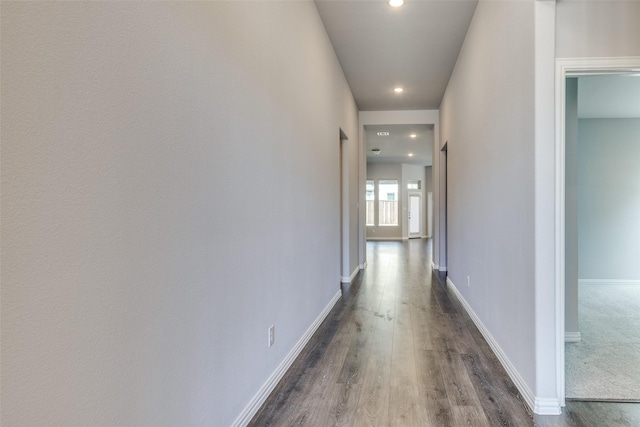 corridor with recessed lighting, baseboards, and dark wood-type flooring