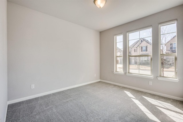 empty room with baseboards and carpet floors