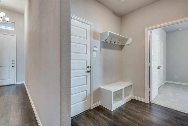 mudroom with baseboards, a notable chandelier, and dark wood finished floors