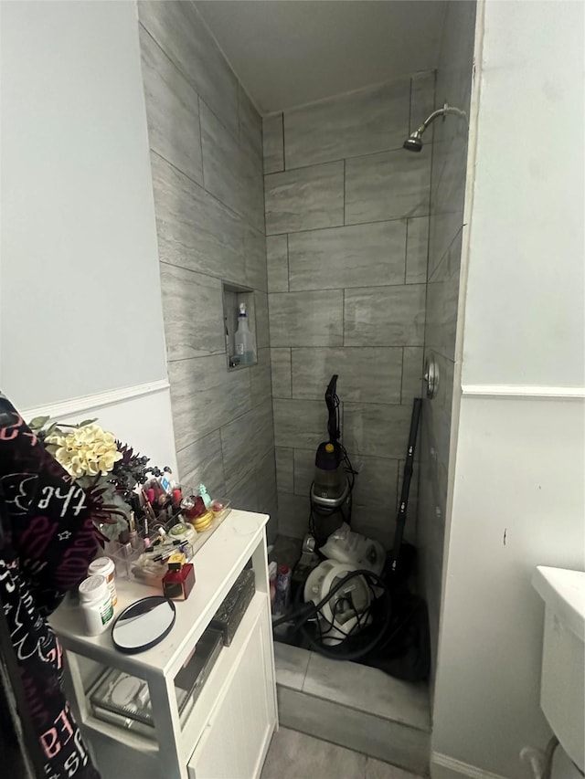 full bath with a tile shower