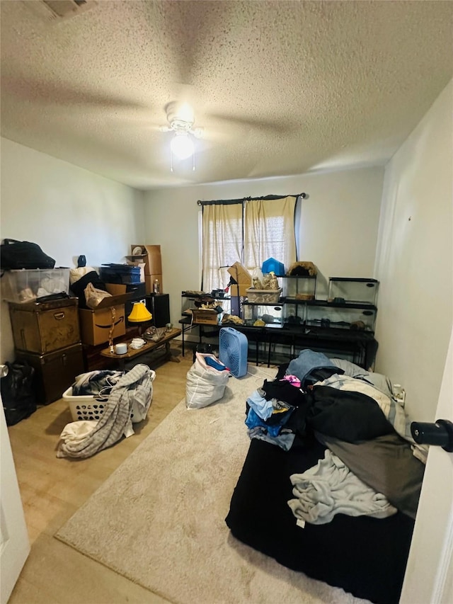 bedroom featuring a ceiling fan and a textured ceiling