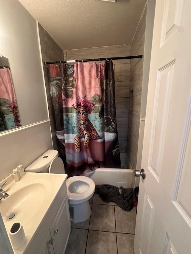 bathroom with vanity, a shower with curtain, tile patterned flooring, a textured ceiling, and toilet