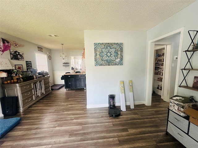 kitchen with visible vents, baseboards, dark wood finished floors, light countertops, and a textured ceiling