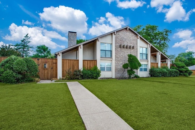 exterior space with a yard, a chimney, and fence