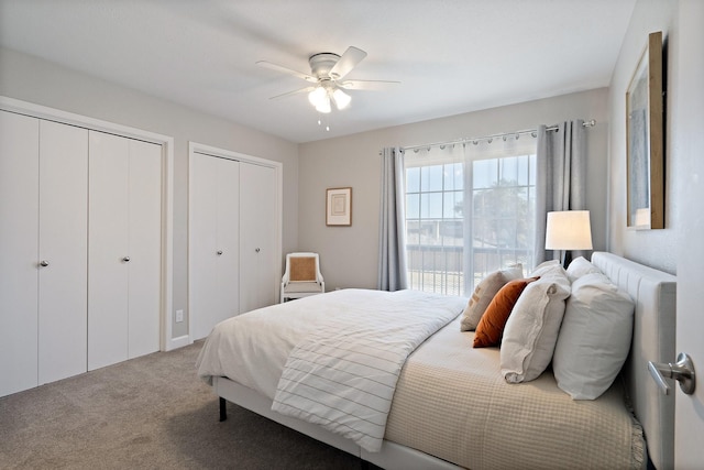 bedroom with two closets, ceiling fan, and carpet floors