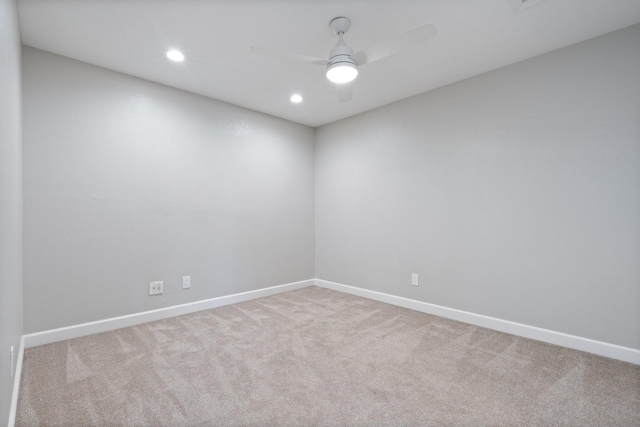 empty room with carpet flooring, recessed lighting, baseboards, and a ceiling fan