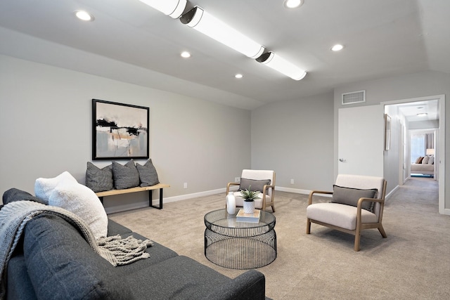 living room featuring vaulted ceiling, recessed lighting, visible vents, and light carpet