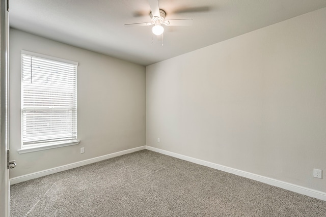 spare room featuring a ceiling fan, baseboards, and carpet floors