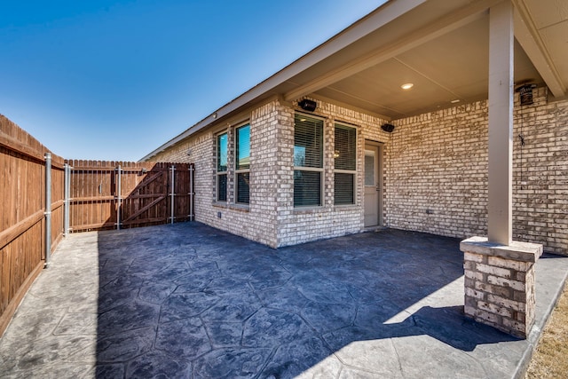 view of patio / terrace featuring a gate and fence