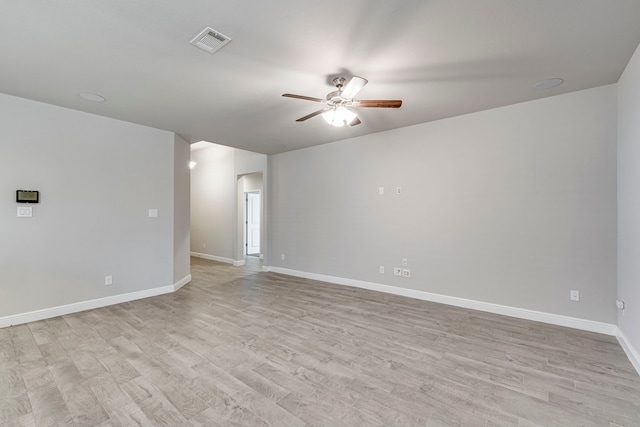 empty room with visible vents, baseboards, light wood-style floors, and a ceiling fan