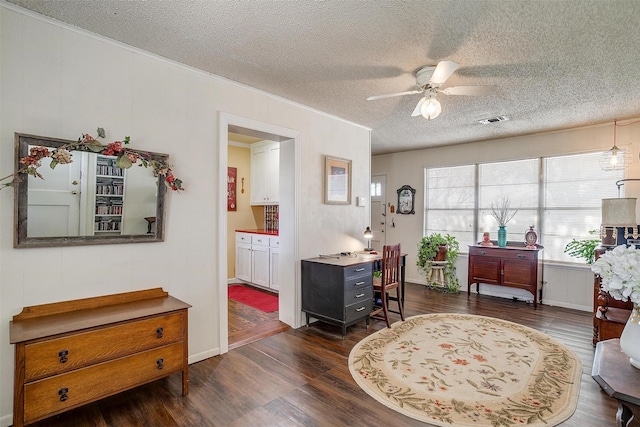 interior space with dark wood finished floors, a textured ceiling, visible vents, and ceiling fan