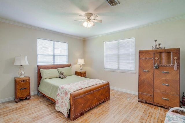 bedroom featuring visible vents, ceiling fan, baseboards, light wood-type flooring, and ornamental molding