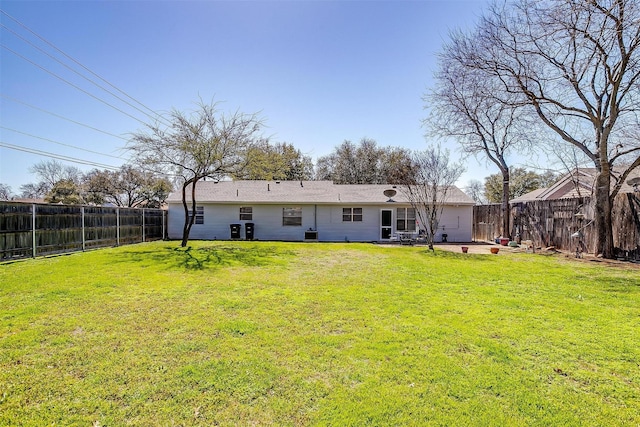 back of property featuring a patio, a yard, and a fenced backyard