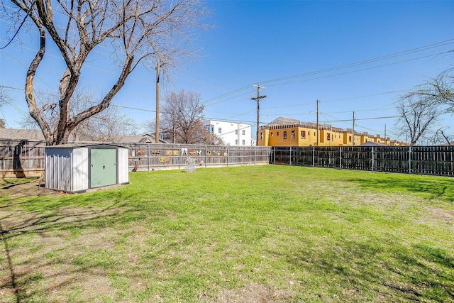 view of yard featuring an outbuilding, a fenced backyard, and a shed