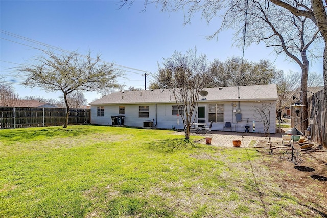 rear view of house featuring a patio, cooling unit, a yard, and fence