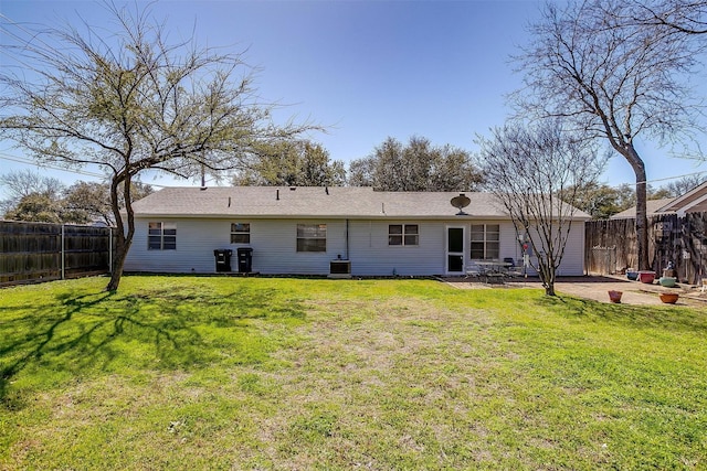 back of house with a patio area, central air condition unit, fence, and a lawn