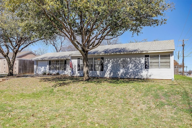 ranch-style house with a garage, a front yard, and fence