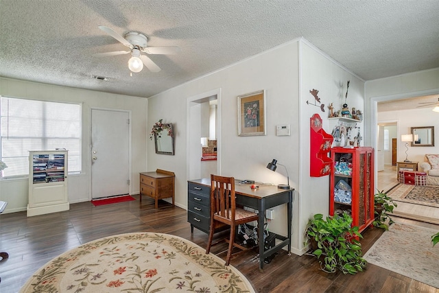 office space with wood finished floors, baseboards, a ceiling fan, visible vents, and a textured ceiling