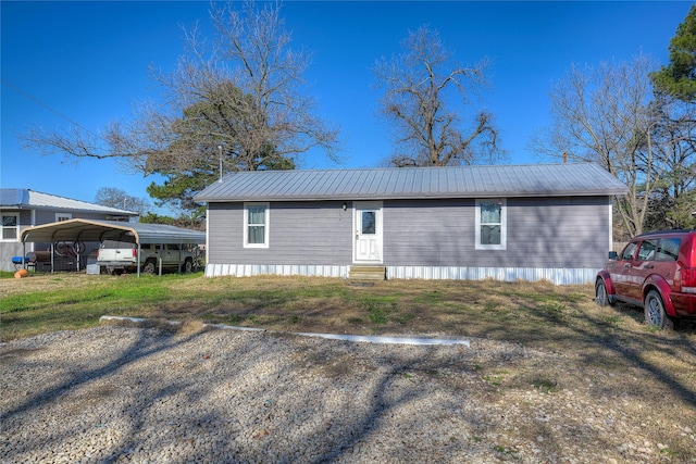 view of front of home with metal roof, a carport, and entry steps