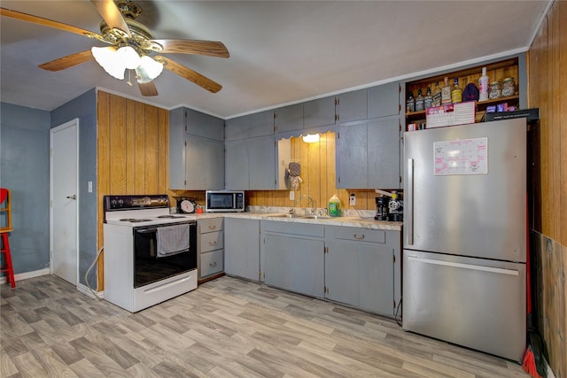 kitchen with a sink, light countertops, gray cabinets, and stainless steel appliances