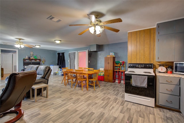 kitchen with white electric range oven, visible vents, gray cabinetry, light countertops, and light wood-type flooring