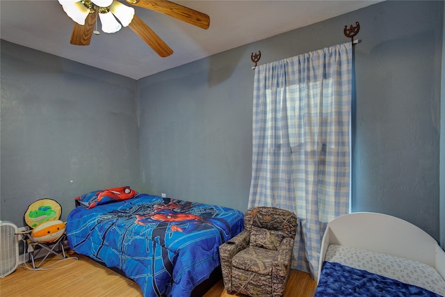 bedroom with wood finished floors and ceiling fan