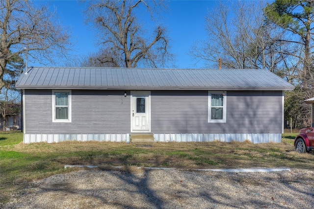 exterior space featuring entry steps and metal roof