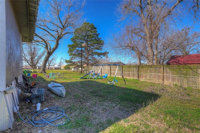 view of yard featuring a playground and fence