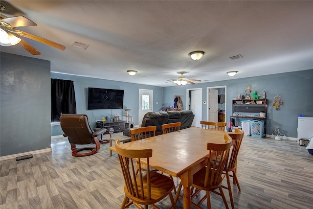 dining room featuring visible vents, baseboards, and wood finished floors