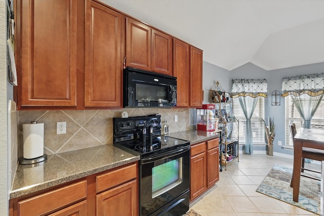 kitchen featuring black appliances, tasteful backsplash, light tile patterned floors, baseboards, and vaulted ceiling