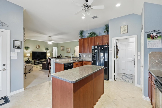 kitchen with open floor plan, a peninsula, black appliances, a ceiling fan, and a sink