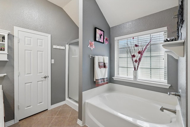 full bathroom featuring tile patterned flooring, a shower stall, lofted ceiling, a textured wall, and a bath