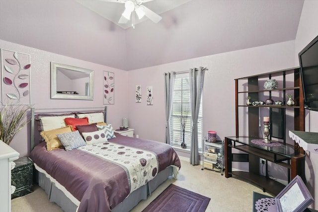 carpeted bedroom featuring lofted ceiling and a ceiling fan