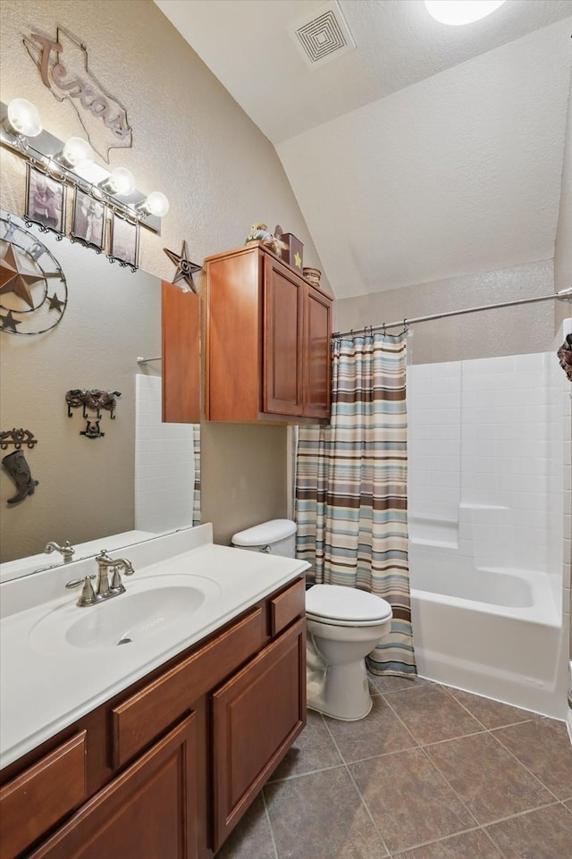 full bathroom with vanity, visible vents, vaulted ceiling, tile patterned floors, and toilet