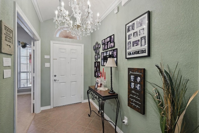 tiled entryway featuring crown molding and baseboards