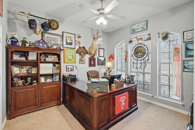 office with light colored carpet, baseboards, and ceiling fan