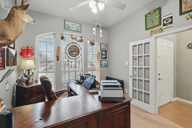 office space featuring light tile patterned floors, light colored carpet, and ceiling fan