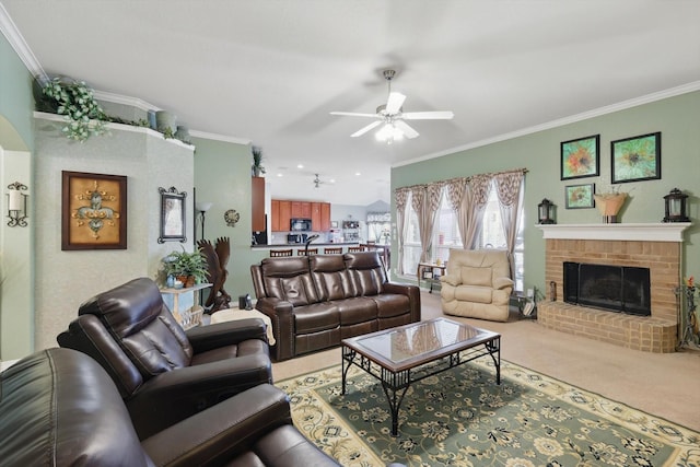 carpeted living area with a fireplace, a ceiling fan, and ornamental molding