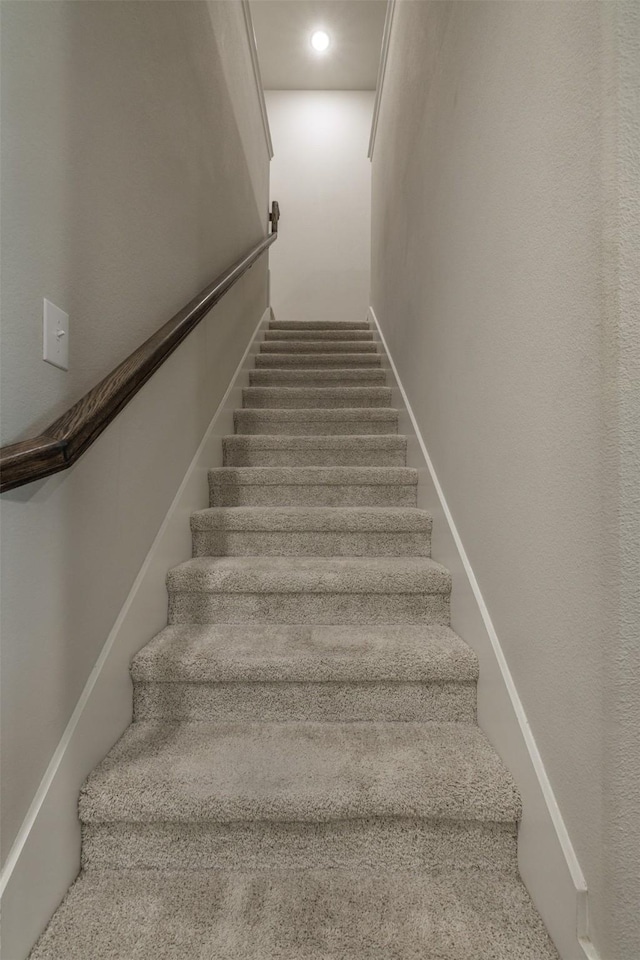 stairs featuring recessed lighting