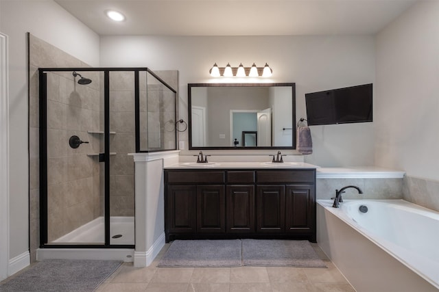 bathroom featuring a sink, a garden tub, a shower stall, and tile patterned flooring