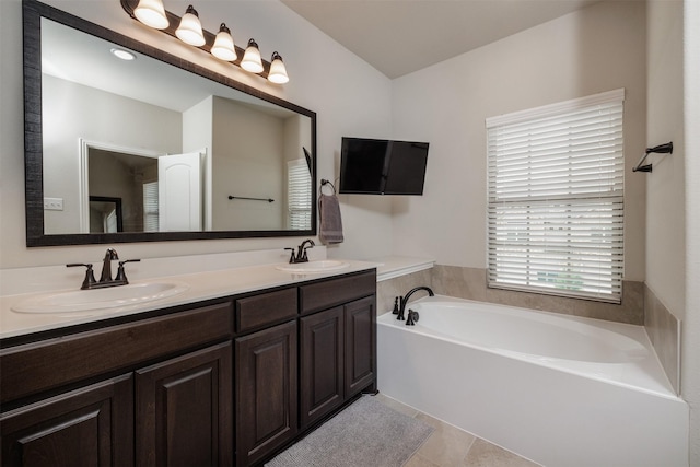 full bathroom with a garden tub, double vanity, tile patterned floors, and a sink