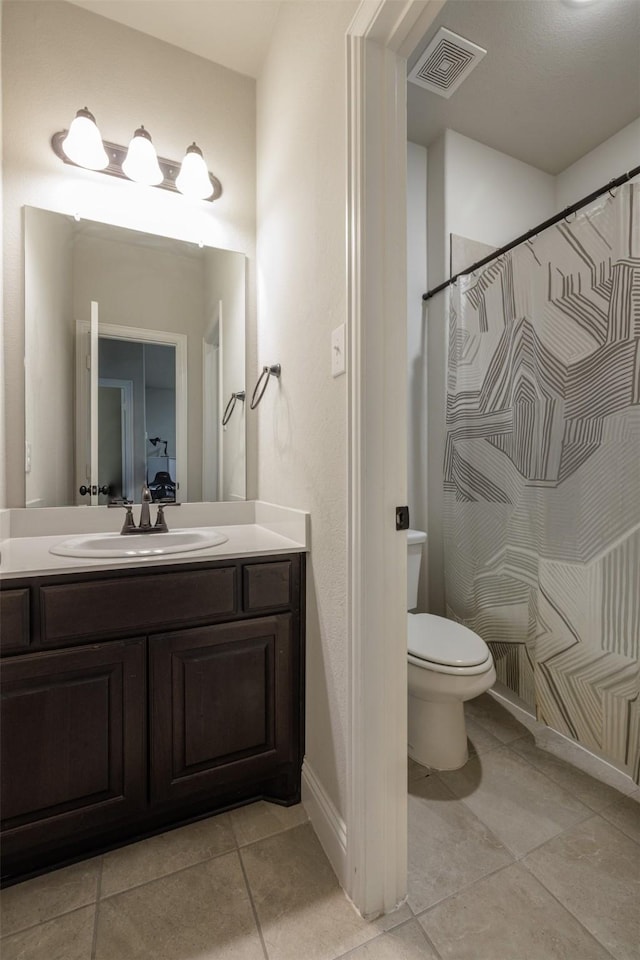 bathroom featuring tile patterned floors, visible vents, toilet, baseboards, and vanity