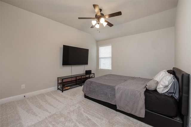 carpeted bedroom with a ceiling fan, baseboards, and vaulted ceiling