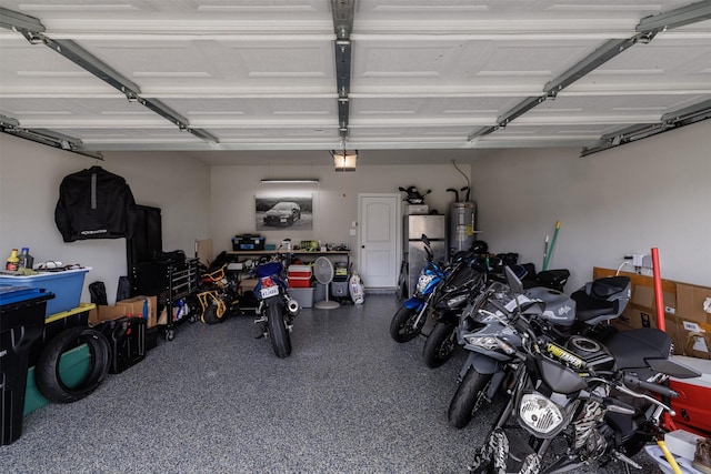 garage with electric water heater and a garage door opener